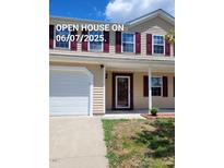 Inviting two-story home featuring a covered porch, maroon shutters, and a well-maintained lawn at 2121 Lime St, Durham, NC 27704