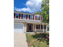 Charming two-story home featuring a two-car garage, and a welcoming front porch at 2121 Lime St, Durham, NC 27704