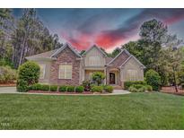 Beautiful home featuring stone accents, manicured lawn, and professional landscaping at 216 Colonial Ridge Dr, Pittsboro, NC 27312