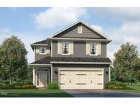 Charming two-story home with gray siding, white trim, and a two-car garage nestled among lush landscaping at 243 New Twin Br Ct, Smithfield, NC 27577