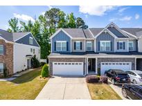 Inviting townhome with a two-car garage and a manicured lawn in a well-kept neighborhood at 2727 Masonboro Ferry Dr, Apex, NC 27502