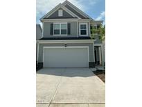 Charming two-story home featuring a two-car garage, gray siding and decorative shutters at 3112 Star Gazing Ln, Durham, NC 27703