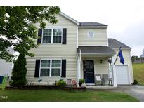 Charming two-story home featuring a well-maintained lawn and inviting front porch at 3848 Griffis Glen Dr, Raleigh, NC 27610