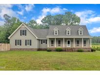 Charming two-story home with a welcoming front porch and well-maintained lawn at 397 Meadow Rd, Kenly, NC 27542