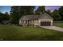 Charming single-Gathering home with a well-manicured lawn, two-car garage, and inviting front porch at 422 River Ridge Ln, Timberlake, NC 27583