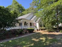 Charming single-Gathering home featuring a welcoming porch and landscaped front yard at 50 Peggy Ct, Raleigh, NC 27603
