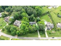 Expansive aerial view showcasing lush landscaping, mature trees, and the neighborhood swimming pool at 5916 Two Pines Trl, Wake Forest, NC 27587