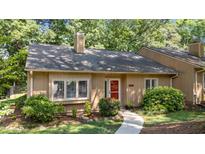 Charming home featuring a red front door, well-maintained landscaping, and a concrete walkway to the entrance at 7918 Yester Ct, Raleigh, NC 27615