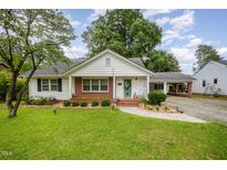 Charming single story home with brick accents, manicured landscaping, and covered parking at 903 S 2Nd St, Smithfield, NC 27577