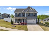Charming two-story home with blue siding, white trim, and a well-manicured front yard at 1002 Addington Lake Ln, Knightdale, NC 27545