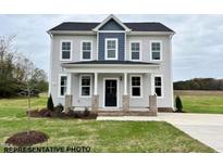 Charming two-story home featuring a welcoming front porch and neatly manicured lawn at 116 Legolas Ct, Middlesex, NC 27557