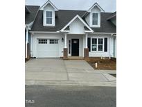 Charming new construction with white siding, a one car garage, and a concrete driveway at 1739 Old Fields Blvd, Haw River, NC 27258