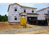 New construction home with Tyvek wrap, portable toilet, and dumpster at 2234 Cherry Creek Rd, Haw River, NC 27258