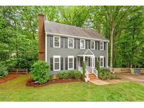Charming two-story home with gray siding, black shutters and a well-manicured lawn at 2300 Cowden Ct, Raleigh, NC 27612