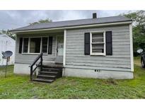 Quaint single-story home featuring horizontal siding and an inviting front entrance at 246 Keene St, Henderson, NC 27536