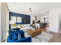 Bright living room featuring a modern chandelier, hardwood floors, and comfortable seating at 2810 Kempthorne Rd # 60, Cary, NC 27519