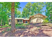 View of the home's exterior showcasing its charming curb appeal and mature landscaping at 3216 Green Valley Dr, Sanford, NC 27330