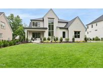 Stunning two-story home with a lush green lawn and manicured landscaping that enhances its curb appeal at 3407 Churchill Rd, Raleigh, NC 27607
