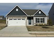 Charming single-story home with stone accents, attached garage, and well-maintained lawn at 400 Access Dr, Youngsville, NC 27596