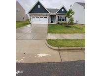Charming single-Gathering home with a well-manicured lawn, two-car garage and stone accents at 400 Access Dr, Youngsville, NC 27596