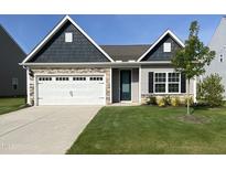 Charming single-story home featuring a manicured lawn, stone accents, and a two-car garage at 400 Access Dr, Youngsville, NC 27596