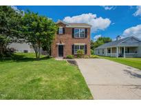 Charming two-story brick home with well-maintained lawn and inviting curb appeal in a residential neighborhood at 5522 Marthonna Way, Raleigh, NC 27616