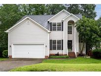 Charming two-story home with vinyl siding, well-maintained landscaping, and a two-car garage at 5629 Yates Garden Ln, Raleigh, NC 27606