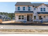 Under construction exterior showing two-story townhome with Tyvek wrap and visible framing at 711 Chandler Stone Dr, Zebulon, NC 27597