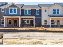 Newly constructed townhomes featuring varied exterior paint colors and brick foundations at 715 Chandler Stone Dr, Zebulon, NC 27597