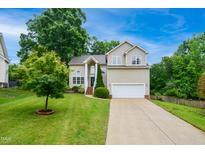 Charming two-story home with a well-manicured lawn, attached garage, and inviting front entrance at 802 Windermere Lake Ct, Apex, NC 27502
