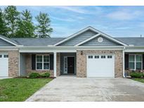 Charming brick home features a one-car garage, inviting curb appeal, and well-maintained landscaping at 905 Alice Ct, Haw River, NC 27258