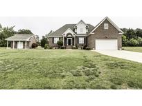 Beautiful brick home with an attached garage and a well-manicured lawn at 9123 Thomas Rd, Rocky Mount, NC 27803