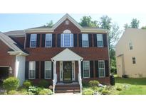 Traditional two-story brick home featuring black shutters and a welcoming front entrance at 919 Middle Ground Ave, Rolesville, NC 27571