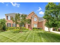 Charming two-story brick home with an arched entry and a well-manicured lawn at 9639 Clubvalley Way, Raleigh, NC 27617
