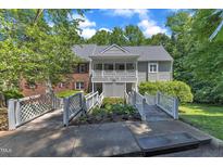 Charming condo with wood bridges leading to a covered porch entry and second story balcony at 101 Oyster Bay Ct # B2, Cary, NC 27513