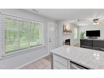 Bright eat-in kitchen features stainless appliances, granite counters and an abundance of natural light at 101 Oyster Bay Ct # B2, Cary, NC 27513