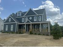 Charming two-story home with a welcoming front porch and beautiful architectural details, and professionally landscaped yard at 1017 Azalea Garden Cir, Raleigh, NC 27603