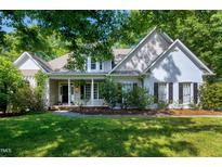 Charming home featuring a welcoming front porch, manicured landscaping and classic architectural details at 108 Ellsworth Pl, Chapel Hill, NC 27516