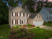 Charming two-story home with a landscaped front yard, inviting entrance, and attached garage at 12325 Amoretto Way, Raleigh, NC 27613