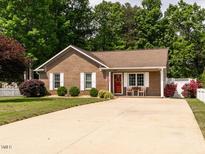 Charming brick home with a well-manicured lawn and inviting front porch at 1290 Pyrtle Dr, Graham, NC 27253