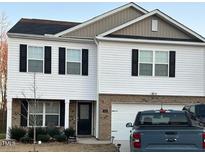 Charming two-story home featuring white siding, black shutters, and an attached two-car garage at 132 Rockfall Way, Rocky Mount, NC 27803