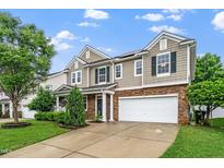 Two-story home showcasing great curb appeal with a driveway, large garage, and established landscaping at 149 Cinder Cross Way, Garner, NC 27529
