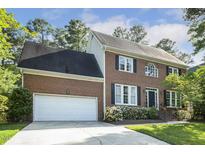 Charming two-story brick home featuring an attached two-car garage and a beautifully landscaped front yard at 1601 Castalia Dr, Cary, NC 27513