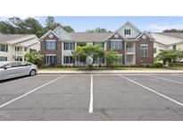 Charming two-story condo with brick and white siding and well-maintained landscaping at 1723 Kudrow Ln, Morrisville, NC 27560