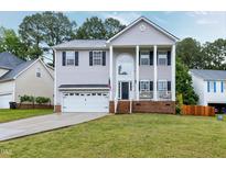 Charming two-story home featuring a manicured lawn and a classic architectural design at 2003 Pilot Mountain Ct, Apex, NC 27502