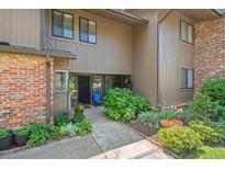 Charming townhouse featuring a well-maintained yard with mature shrubs and inviting front entrance at 202 Oak Tree Dr, Chapel Hill, NC 27517