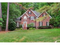 Charming two-story brick home with manicured lawn and lush landscaping at 204 Middlestone Ct, Wake Forest, NC 27587