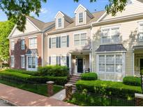 Charming townhome with a manicured lawn, brick accents, and a welcoming front porch with brick steps at 2503 Saint Pauls Sq, Raleigh, NC 27614