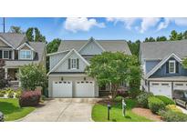 Charming two-story home with a well-manicured lawn and a two-car garage at 2721 Cameron Pond Dr, Cary, NC 27519