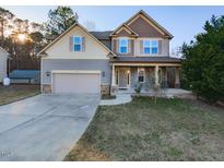 Charming two-story home featuring a two-car garage, inviting front porch, and a well-maintained lawn at 333 Bald Head Island Dr, Garner, NC 27529